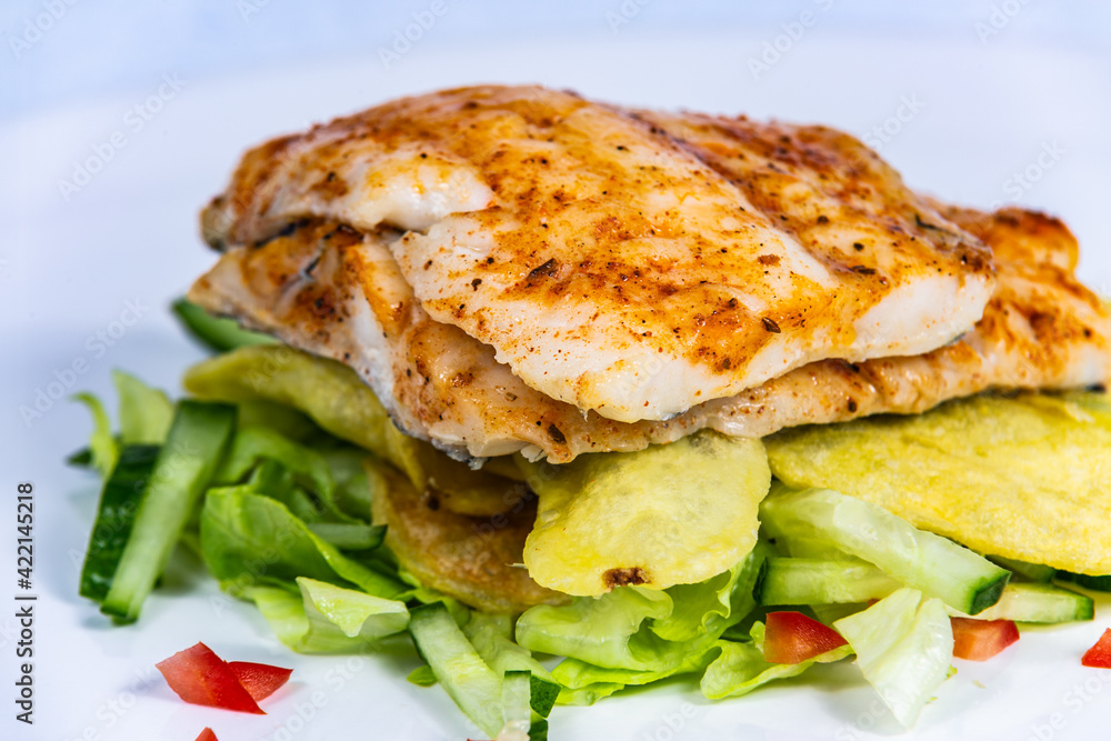 Grilled zander with potatoes and vegetables. Food styling for street food. Closeup. Grilled zander with potatoes and vegetables. Food styling for street food. Closeup.