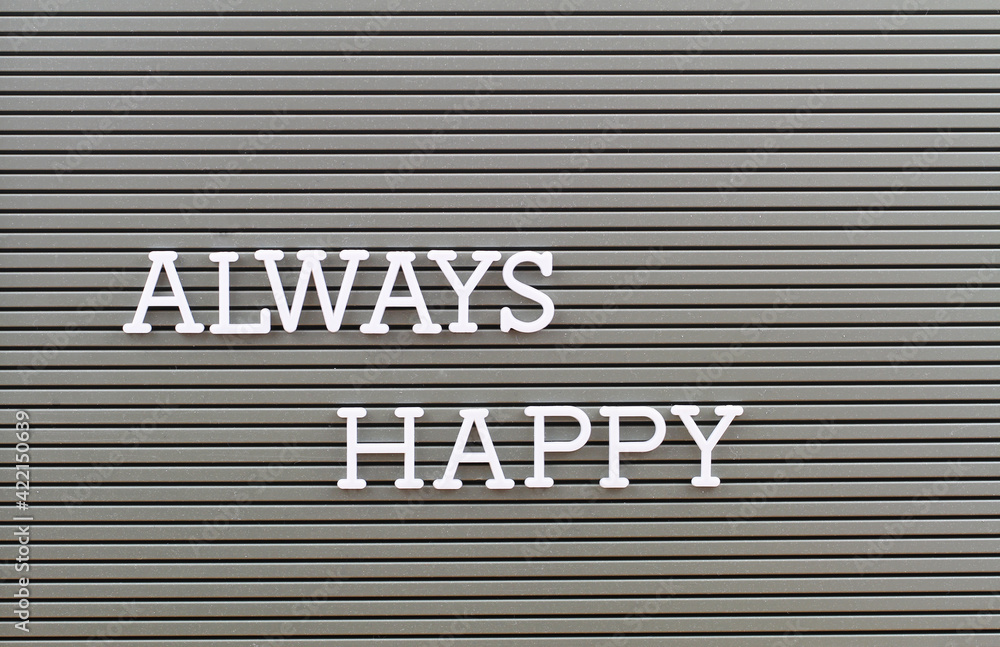 Always happy written on plastic grey board