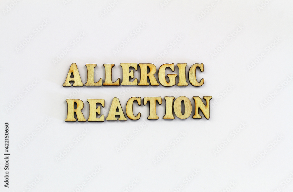 Allergic reaction written with wooden letters on white background