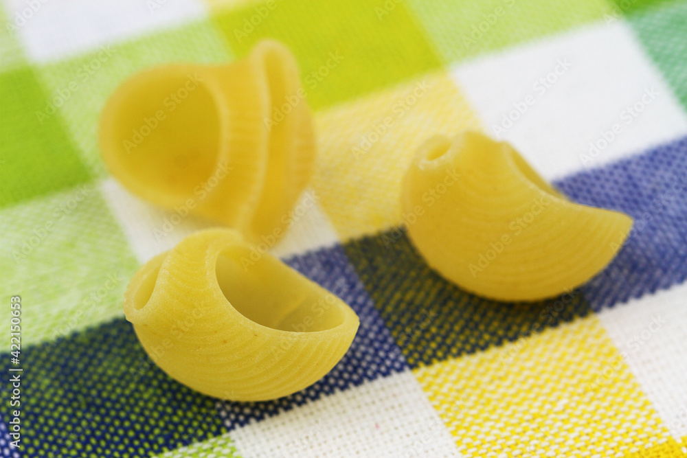 Closeup of uncooked pasta on kitchen cloth
