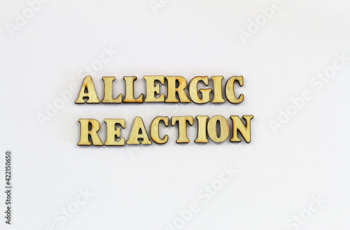 Allergic reaction written with wooden letters on white background 