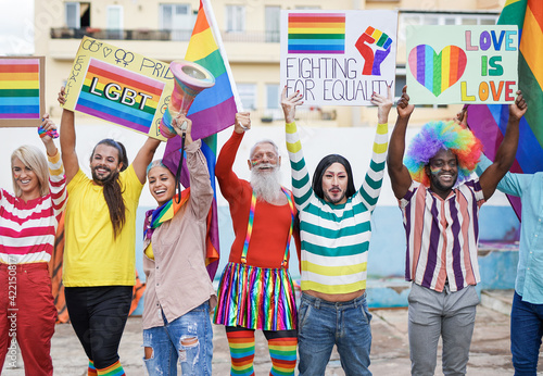 Multiracial gay people from different generations having fun at lgbt pride parade - Concept of homosexual and transgender love