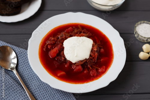 Borscht in a plate on a gray background