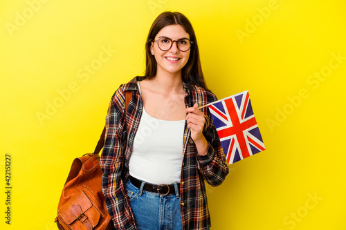 Young woman studying English isolated on pink background happy, smiling and cheerful.