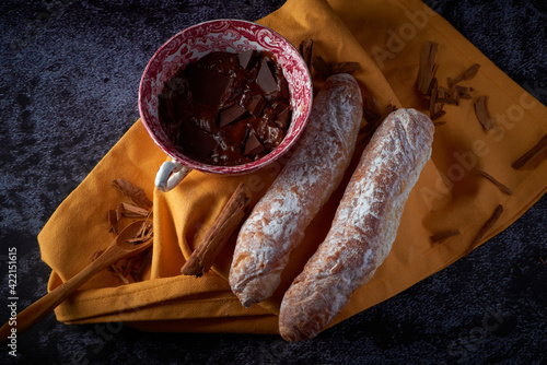 Fartons, typical pastries from Valencia, Spain, with hot chocolate. A sweet breakfast or snack. photo