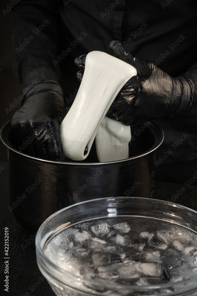 Cheese maker preparing mozzarella cheese