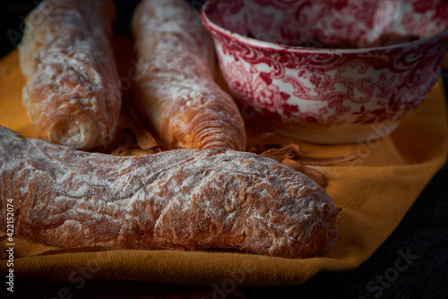 Fototapeta Naklejka Na Ścianę i Meble -  Fartons, typical pastries from Valencia, Spain, with hot chocolate. A sweet breakfast or snack.