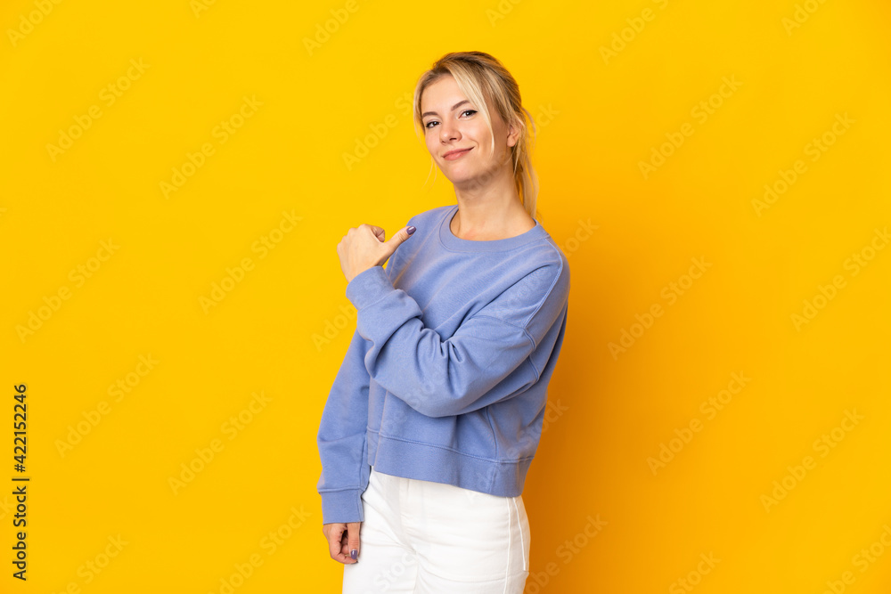 Young Russian woman isolated on yellow background proud and self-satisfied Young Russian woman isolated on yellow background proud and self-satisfied
