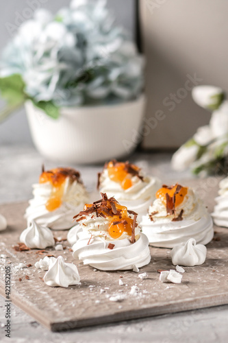 Mini pavlova meringue cakes on light background