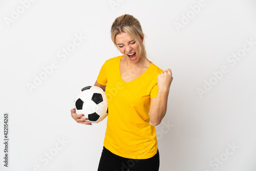 Young Russian woman isolated on white background with soccer ball celebrating a victory © luismolinero