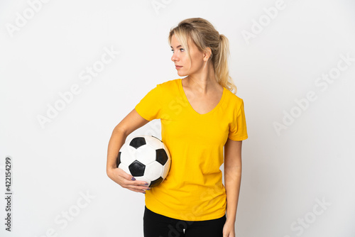 Young Russian woman isolated on white background with soccer ball © luismolinero