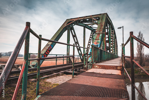 An old rusty railway bridge with a dramatic sky © blanke1973