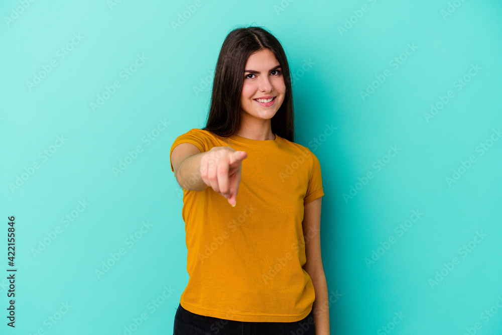 Young caucasian woman isolated on blue background pointing to front with fingers. Young caucasian woman isolated on blue background pointing to front with fingers.