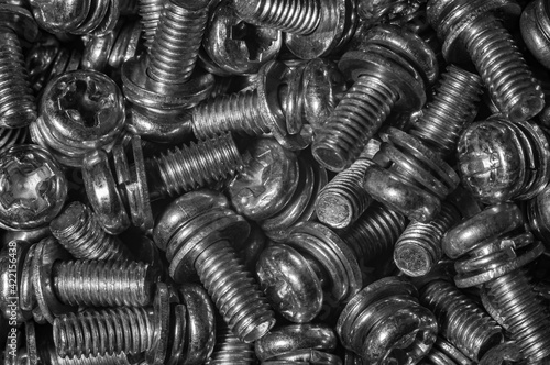 many galvanized screws, set with washer and grover, black and white macro photo
