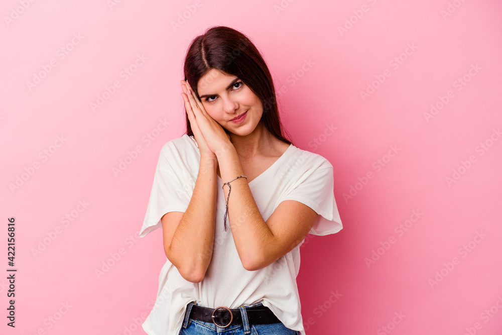 Young caucasian woman isolated on pink background yawning showing a tired gesture covering mouth with hand. Young caucasian woman isolated on pink background yawning showing a tired gesture covering mouth with hand.