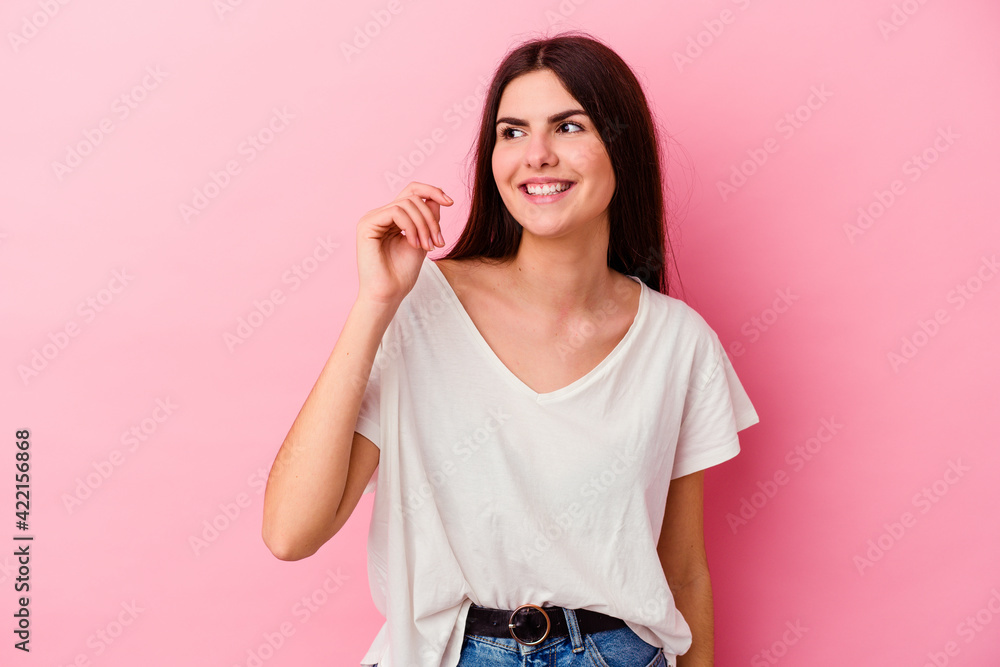Young caucasian woman isolated on pink background laughing about something, covering mouth with hands. Young caucasian woman isolated on pink background laughing about something, covering mouth with hands.