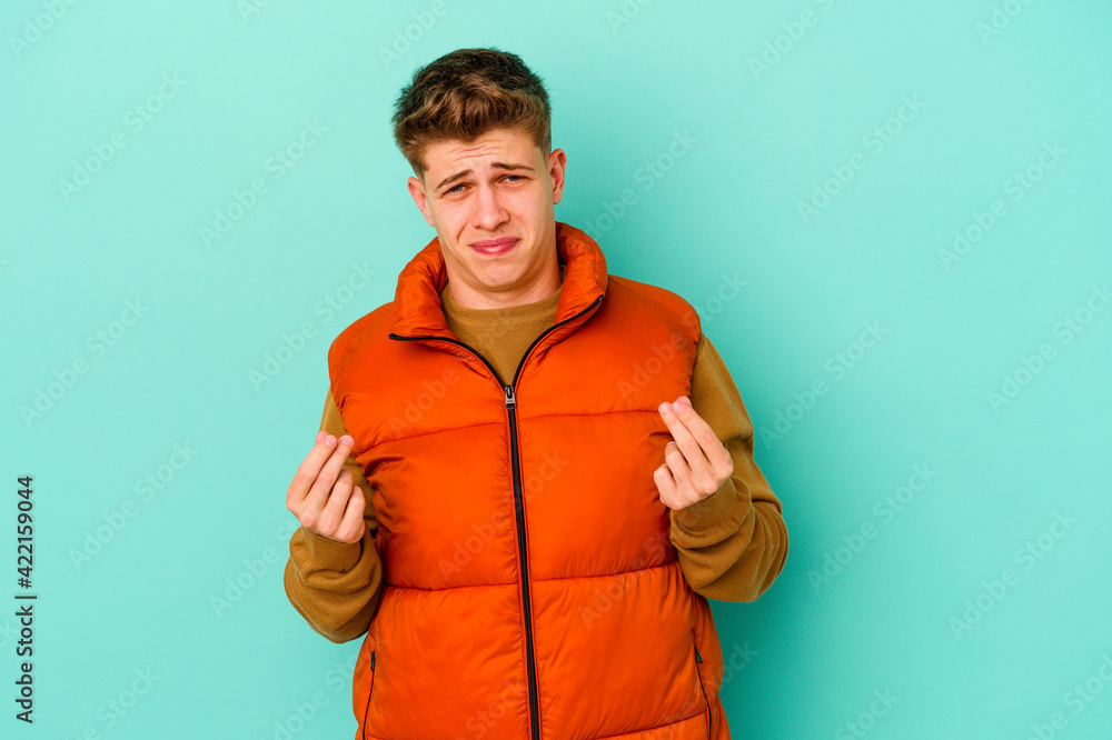 Young caucasian man isolated on blue background showing that she has no money. Young caucasian man isolated on blue background showing that she has no money.