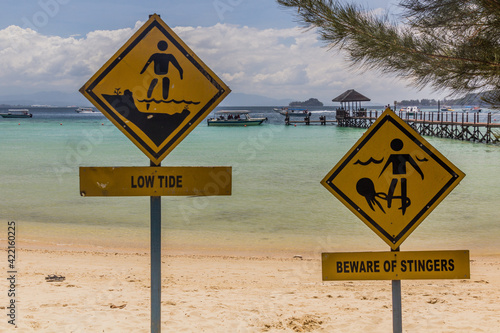 Signs Low Tide and  Beware of Stingers at Gaya Island in Tunku Abdul Rahman National Park, Sabah, Malaysia