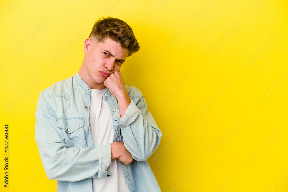 Fototapeta premium Young caucasian man isolated on yellow background who feels sad and pensive, looking at copy space.