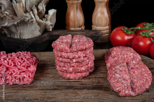 Raw meatballs is ready to be cooked. Raw Minced Beef Butcher Meatballs, Turkish name; Kasap Kofte - on a black background. photo