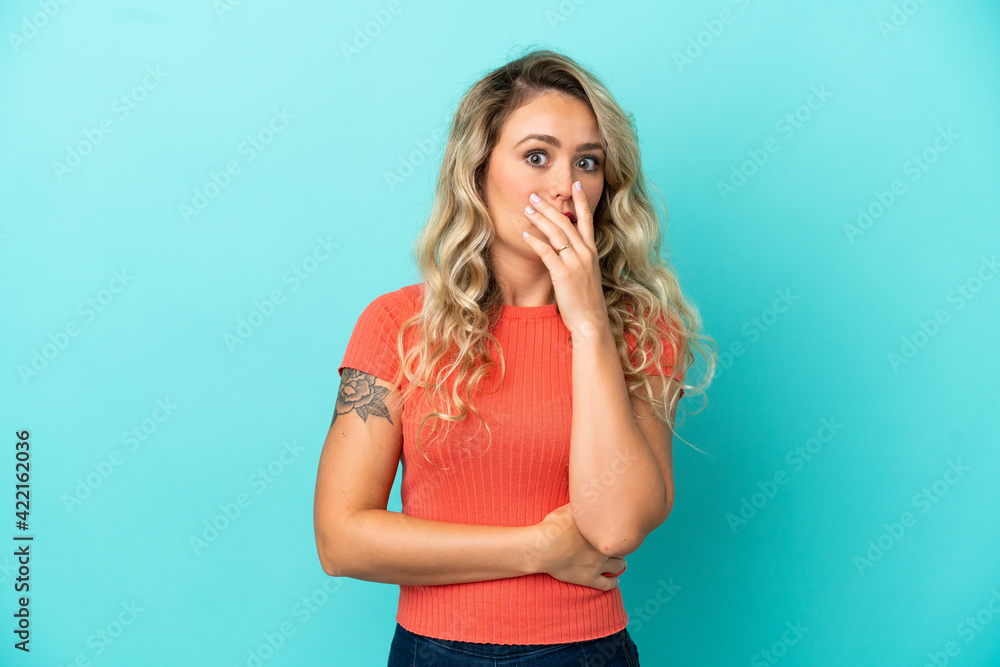 Young Brazilian woman isolated on blue background surprised and shocked while looking right Young Brazilian woman isolated on blue background surprised and shocked while looking right