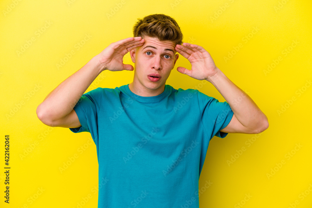 Young caucasian man isolated on yellow background celebrating a victory or success, he is surprised and shocked. Young caucasian man isolated on yellow background celebrating a victory or success, he is surprised and shocked.