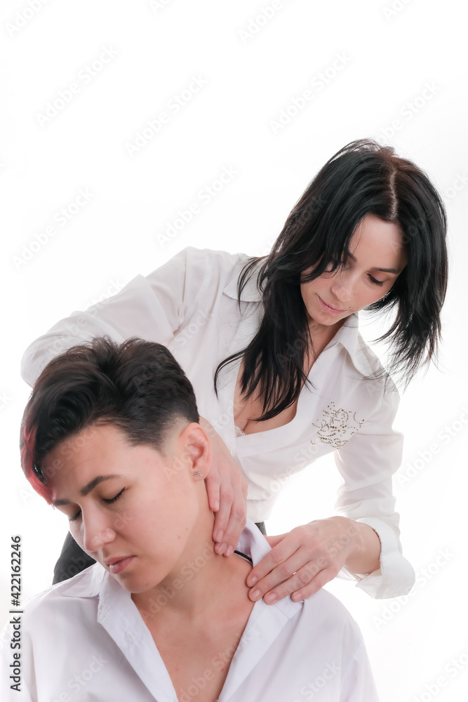 Woman masseur makes to girl client neck massage, relief of headache and tension, copy space Woman masseur makes to girl client neck massage, relief of headache and tension, copy space