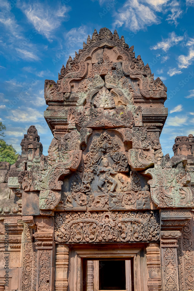 Banteay Srei - Cambodian temple dedicated to the Hindu god Shiva. Ancient Khmer ruins in the jungle. Red sandstone monument. Bas-relief depicting the god Shiva on an elephant. High detail and finest