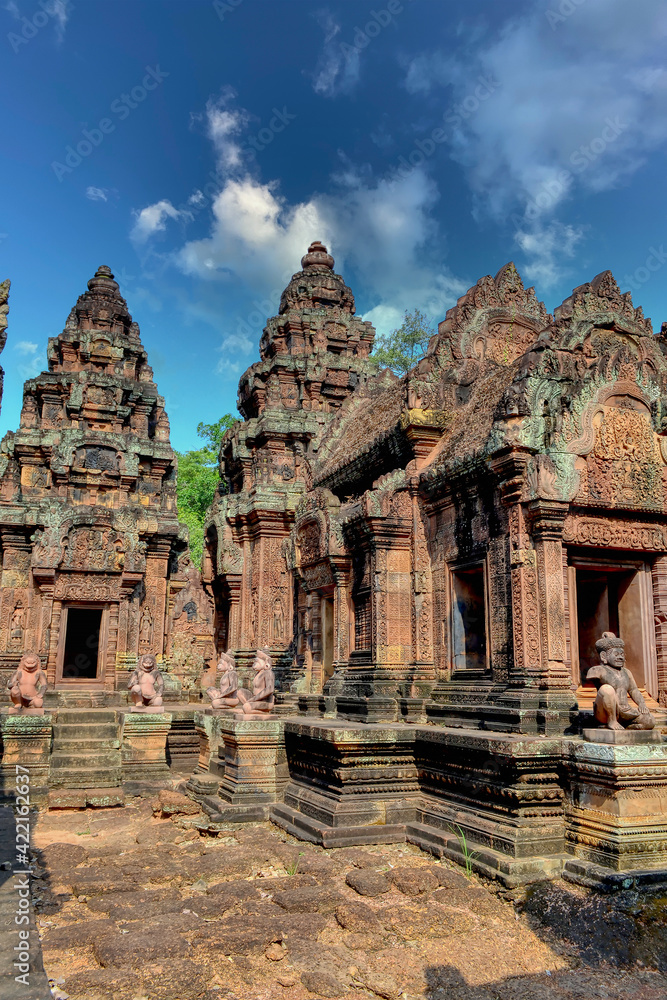 Fototapeta premium Banteay Srei - Cambodian temple dedicated to the Hindu god Shiva. Ancient Khmer ruins in the jungle. Red sandstone monument. The inner courtyard of the temple, the entrance to the sanctuary.