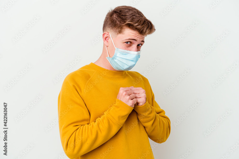 Young man wearing a mask for coronavirus isolated on white background scared and afraid. Young man wearing a mask for coronavirus isolated on white background scared and afraid.