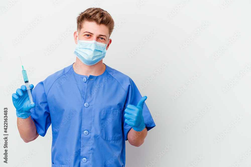Young caucasian nurse man prepared to give a vaccine isolated on white background smiling and raising thumb up Young caucasian nurse man prepared to give a vaccine isolated on white background smiling and raising thumb up