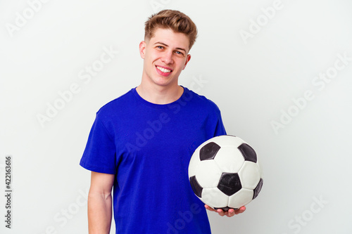 Young caucasian man playing soccer isolated on background happy, smiling and cheerful.
