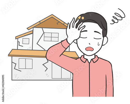 老朽化した家　悩む男性