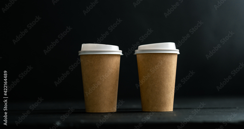 two cups of coffee, tea, latte, cappuccino on a black background two cups of coffee, tea, latte, cappuccino on a black background