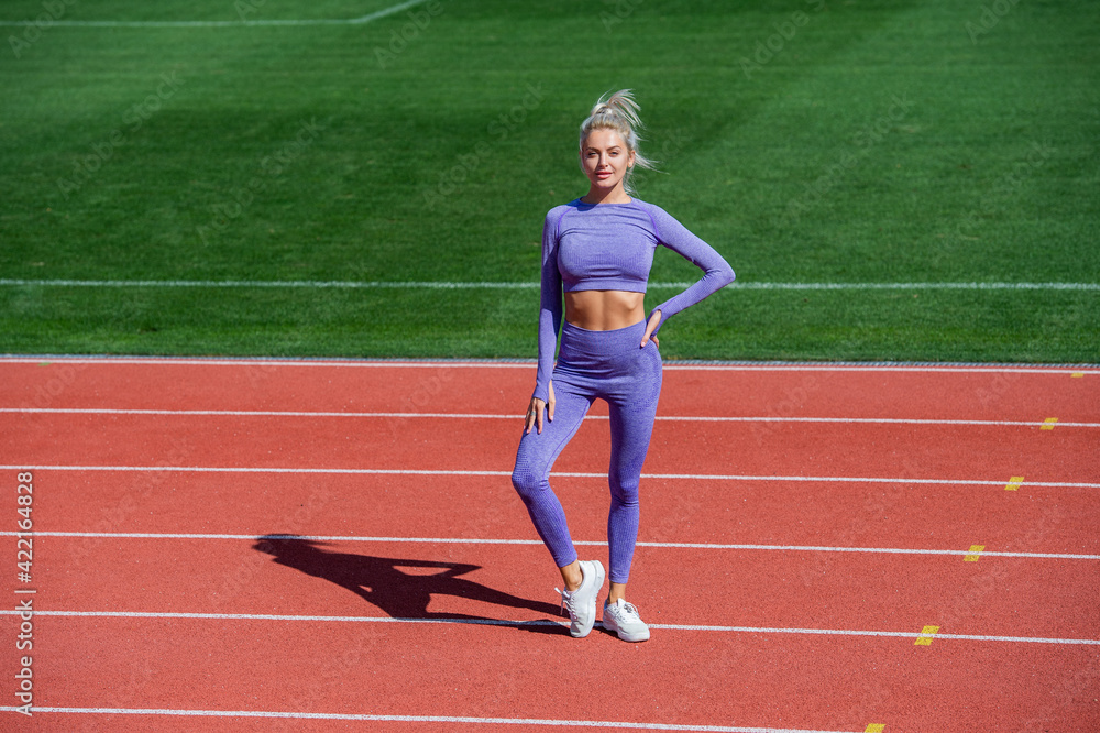 athletic woman in fitness wear on stadium, sport