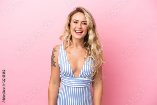 Young Brazilian woman in swimsuit in summer holidays isolated on pink background with surprise facial expression
