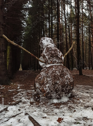 A melted dirty snowman. Spring Forest