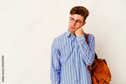Young student man isolated on white background who feels sad and pensive, looking at copy space.