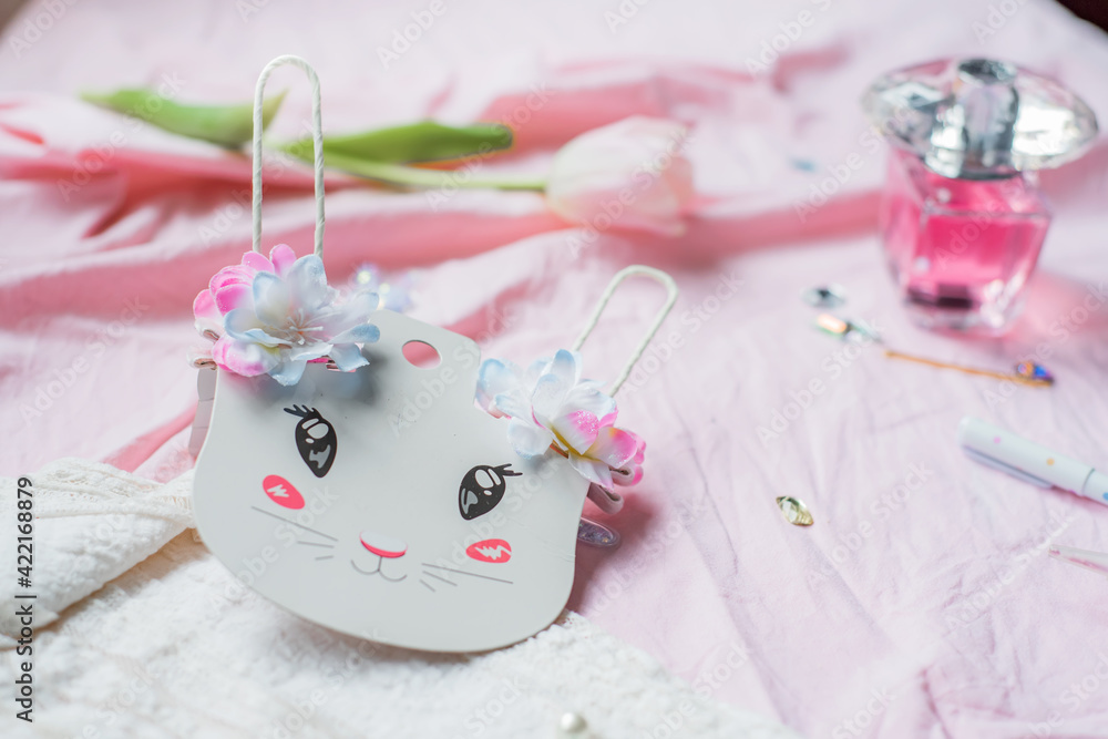 Set of Girly Things. Happy Easter Greeting card.Flower, glitter, parfume and a white bunny ears on pink background. Concept of holiday, birthday, Easter, March 8. Flat lay.