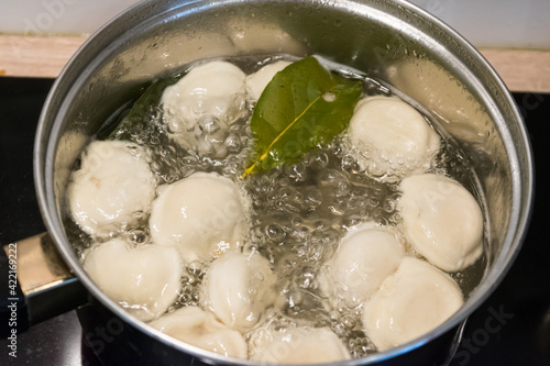 Cooking russian pelmeni. A pot of boiled pelmeni, approx. Boiled water