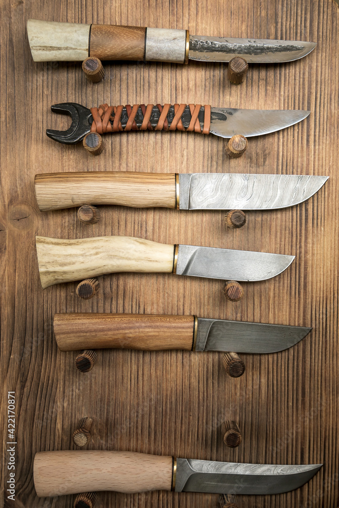 Various handmade knives with ornamental steel