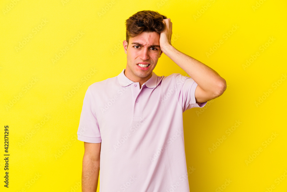 Young caucasian man isolated on yellow background forgetting something, slapping forehead with palm and closing eyes. Young caucasian man isolated on yellow background forgetting something, slapping forehead with palm and closing eyes.