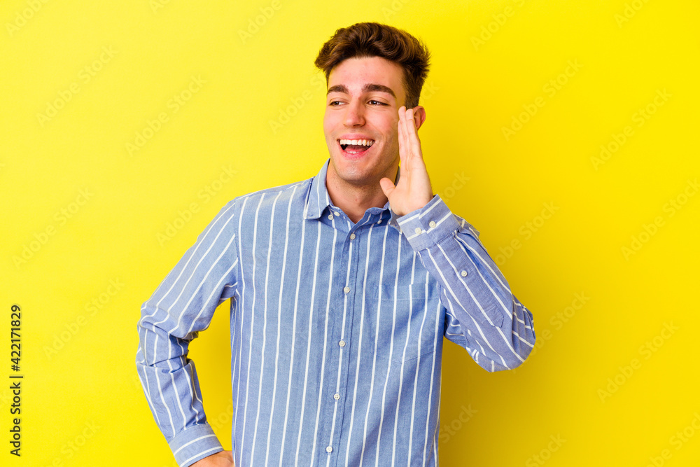 Young caucasian man isolated on yellow background shouting excited to front. Young caucasian man isolated on yellow background shouting excited to front.