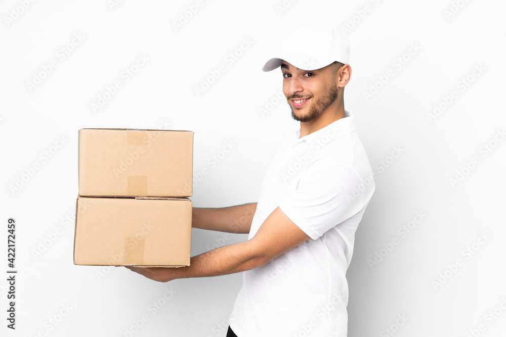 Delivery Arabian man isolated on blue background extending hands to the side for inviting to come Delivery Arabian man isolated on blue background extending hands to the side for inviting to come