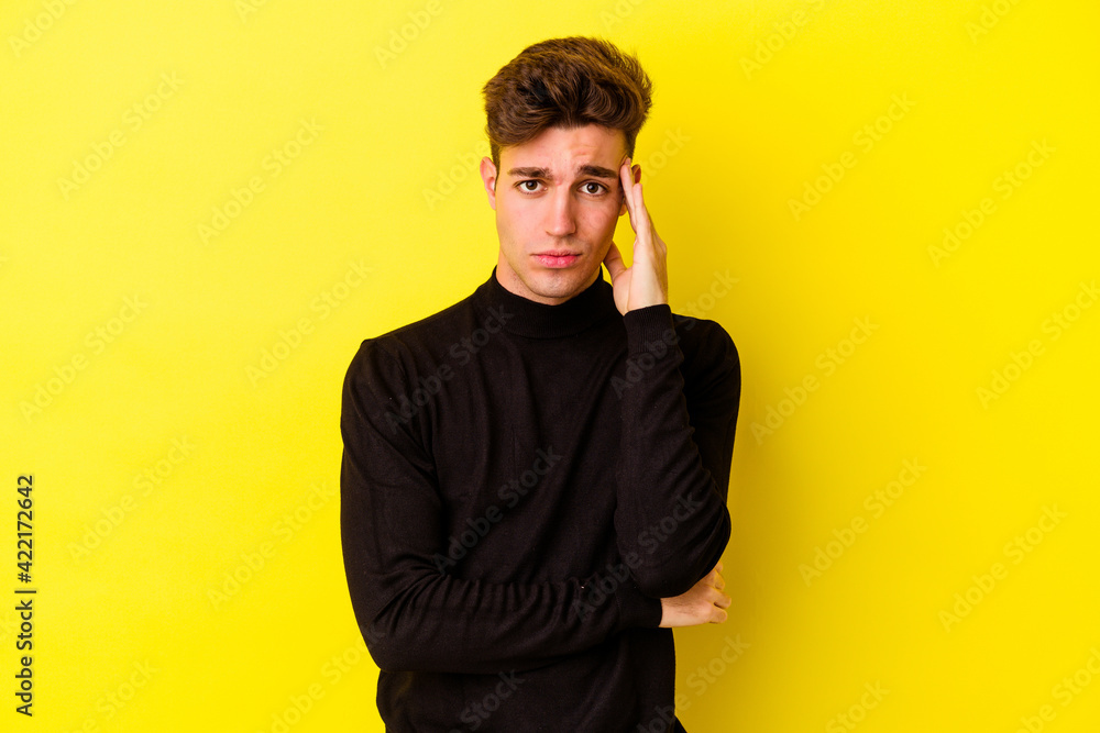 Fototapeta premium Young caucasian man isolated on yellow background blows cheeks, has tired expression. Facial expression concept.