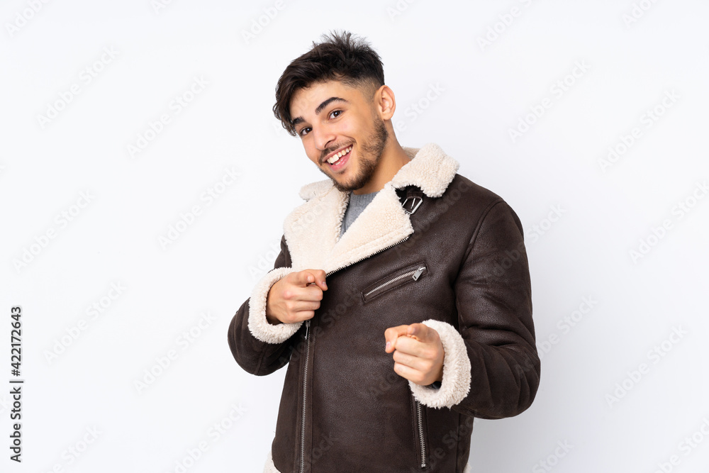 Arabian handsome man over isolated background surprised and pointing front Arabian handsome man over isolated background surprised and pointing front