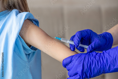 The girl is vaccinated. A vaccine and a syringe for injection