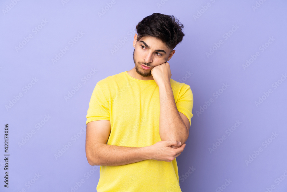 Arabian handsome man over isolated background with tired and bored expression Arabian handsome man over isolated background with tired and bored expression