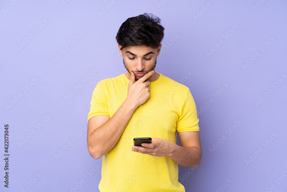 Arabian handsome man over isolated background thinking and sending a message Arabian handsome man over isolated background thinking and sending a message