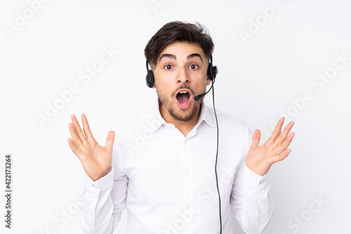 Telemarketer Arabian man working with a headset isolated on white background with surprise facial expression